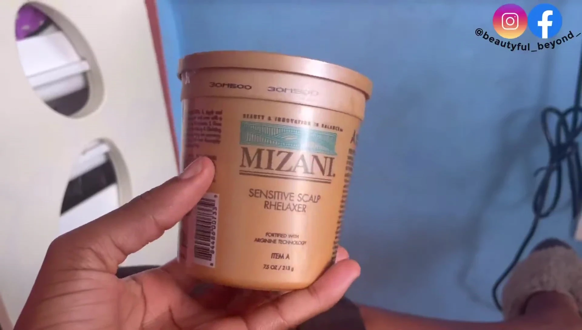 The blogger showing the Mizani Sensitive Scalp Relaxer product.