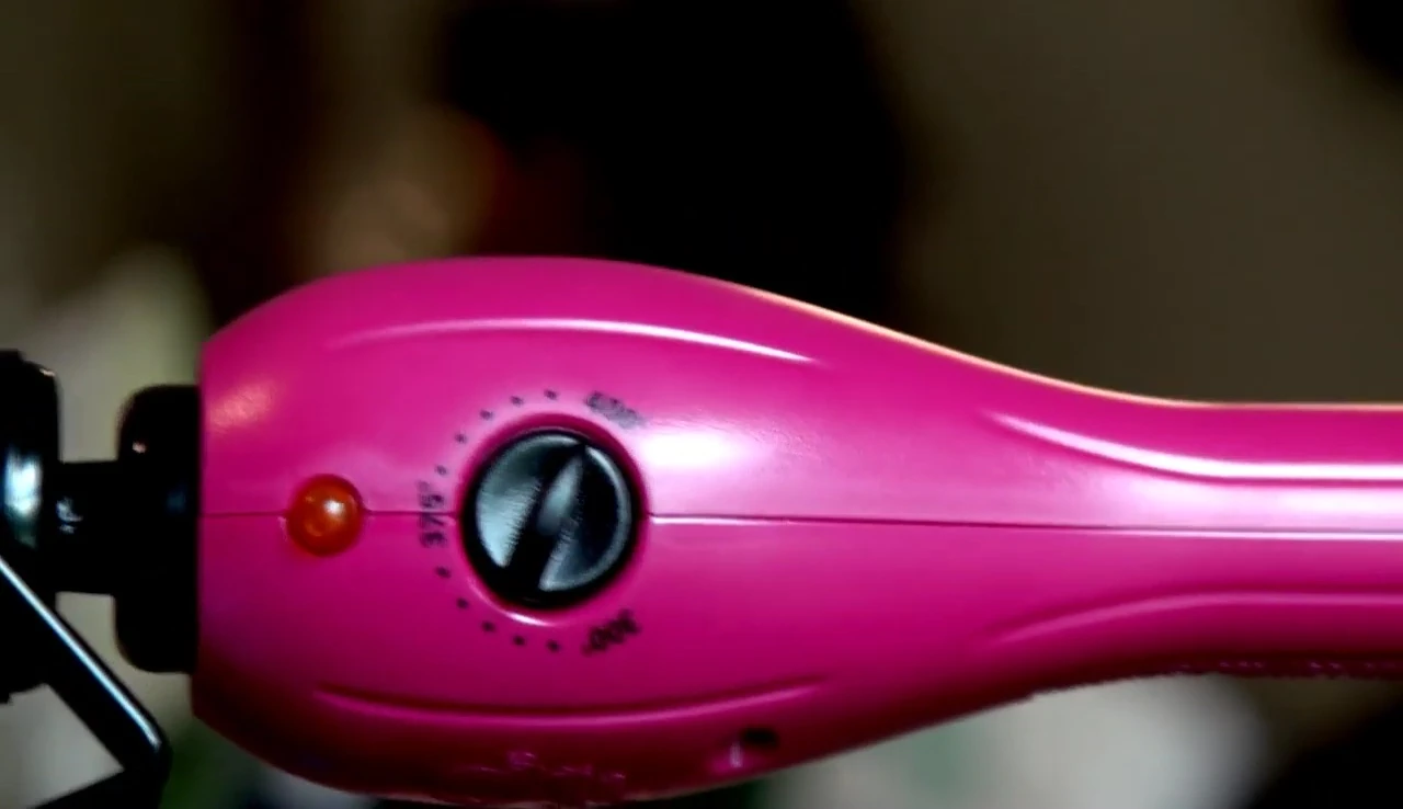The temperature control dial on the curling iron.