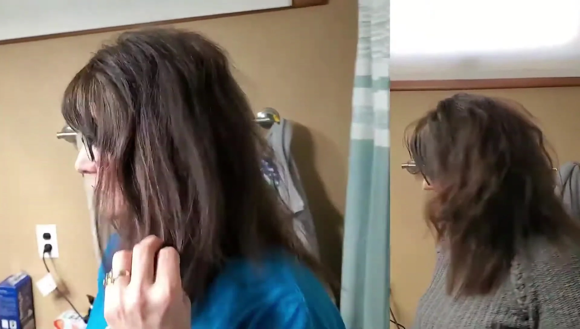 A shot of the reviewer using the brush on their hair.