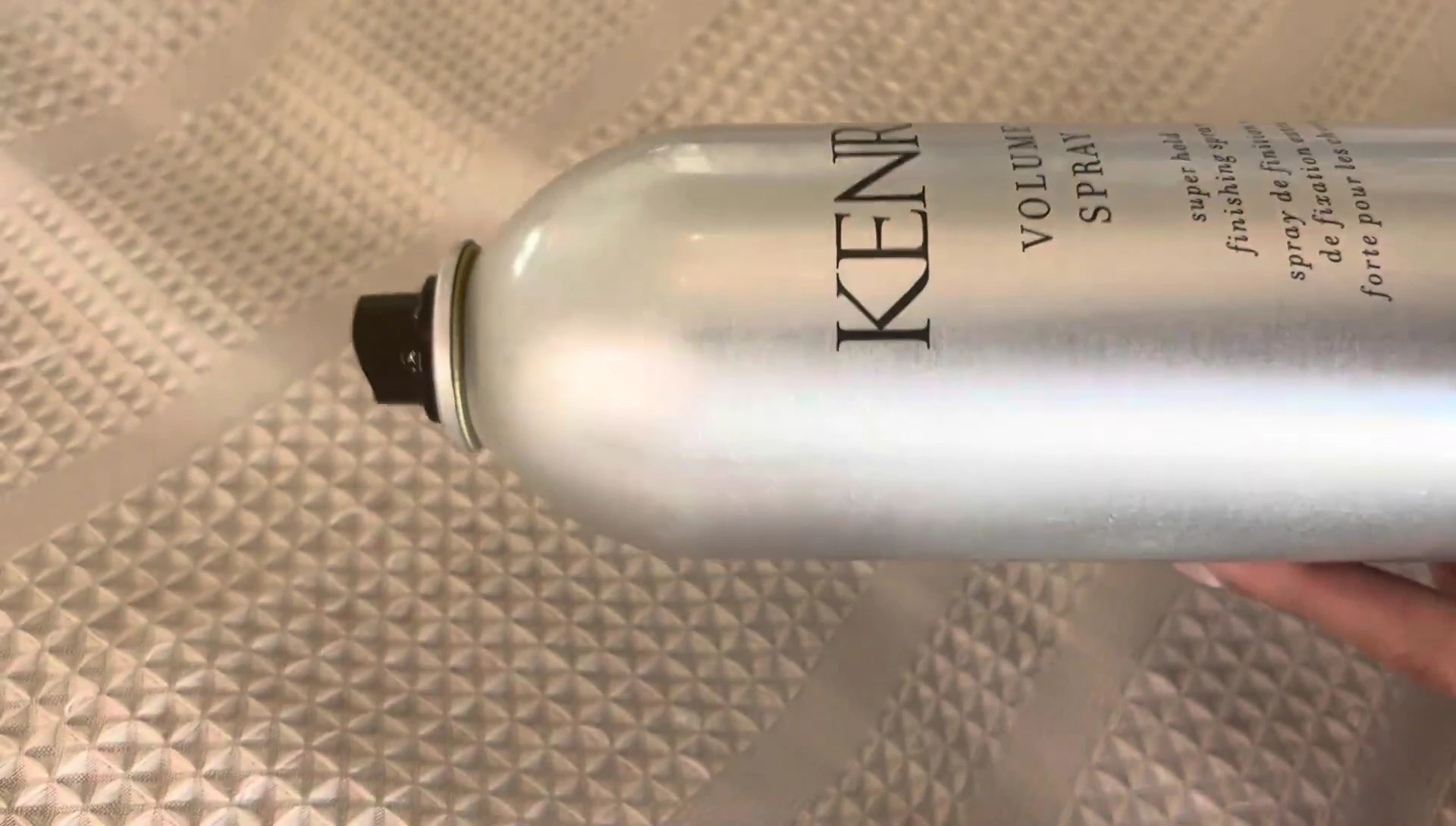 Close-up of hair styled with the spray, highlighting its polished and professional look.