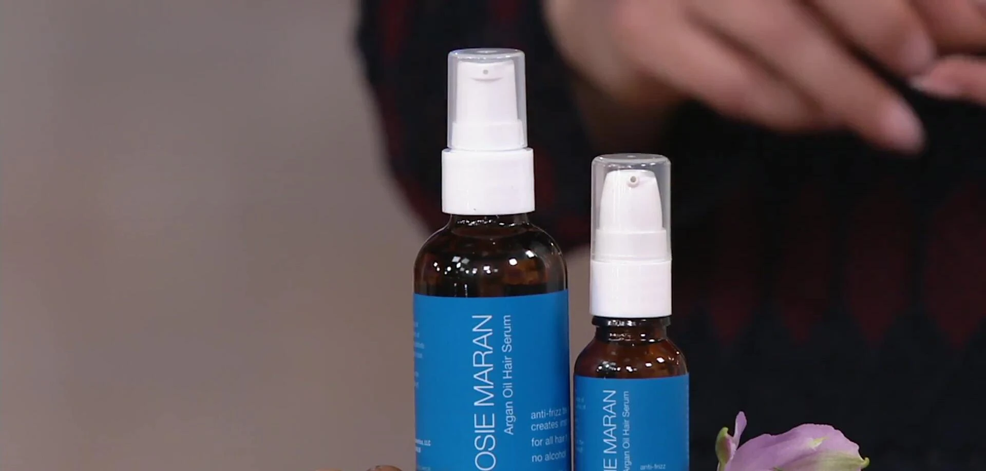 The full-size and travel-size bottles of Josie Maran Argan Hair Serum