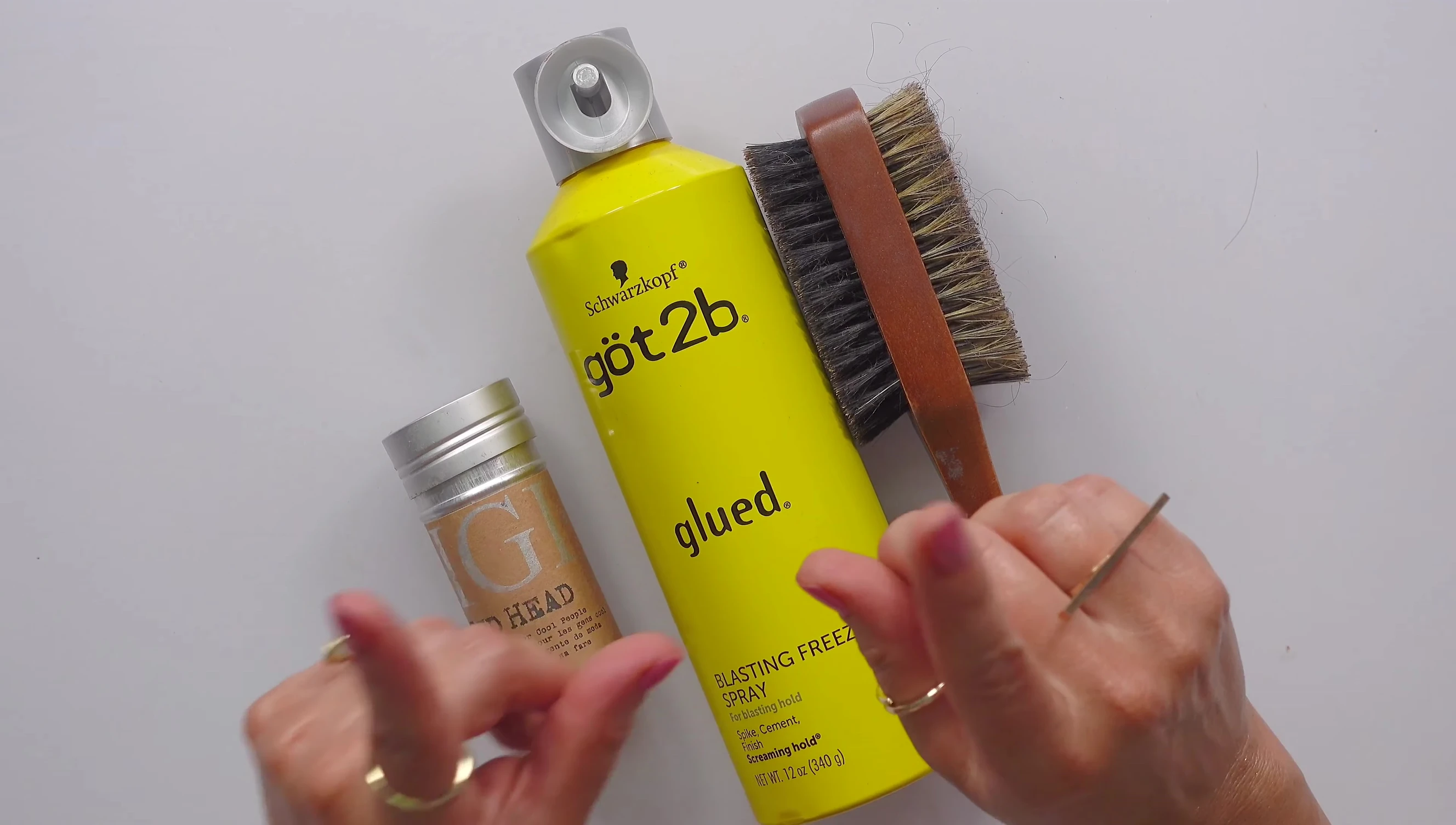 Speaker starts by pulling hair into a loose ponytail.