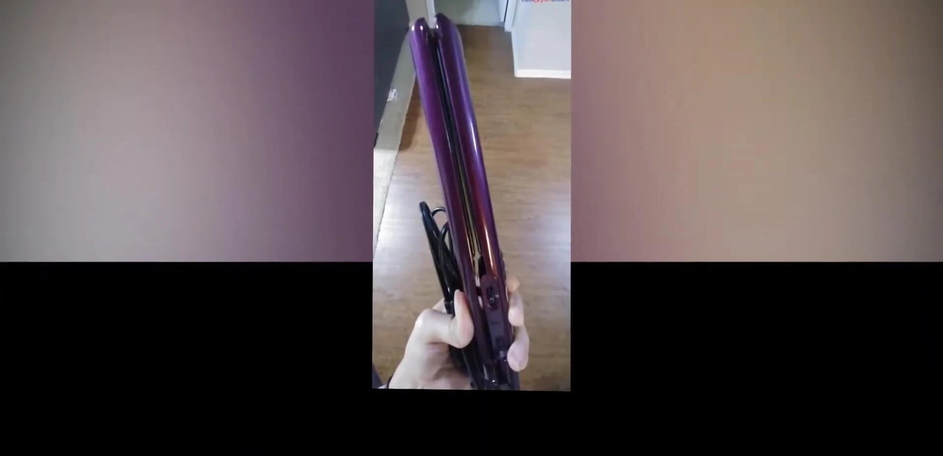 Person using the flat iron to style their hair.