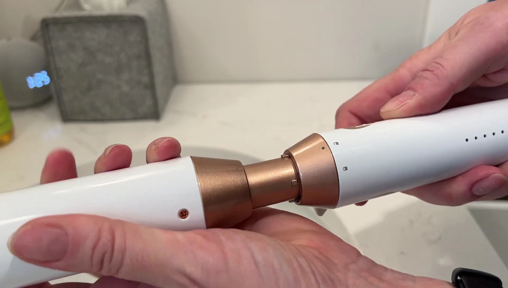 Demonstrating the ease of attaching a curling wand to the base.