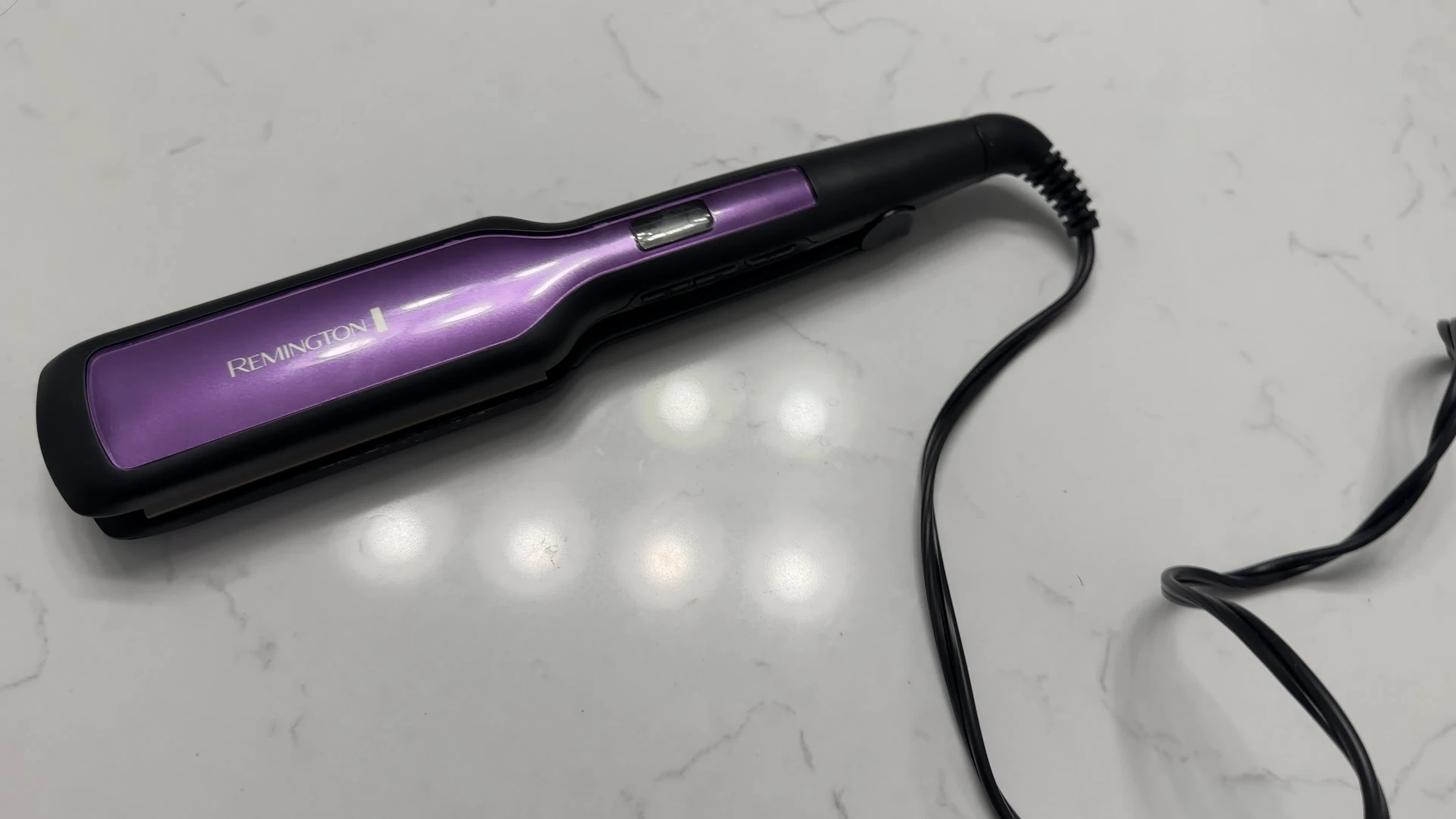 Close-up of the Remington S5522 hair straightener, showing its overall condition after 15 years of use.