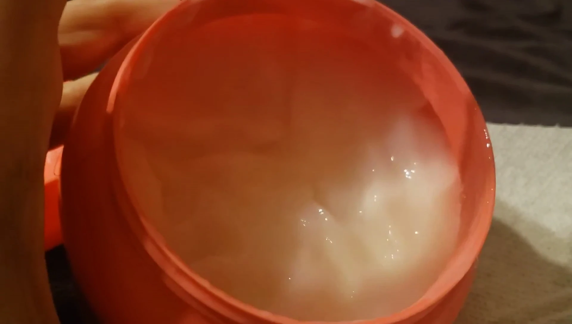 The reviewer showing the texture of the hair mask.