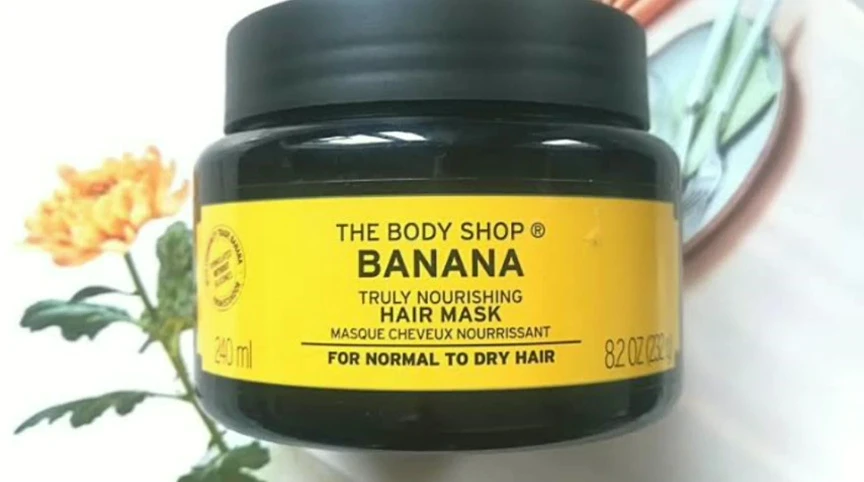 A shot focusing on the hair mask's application process