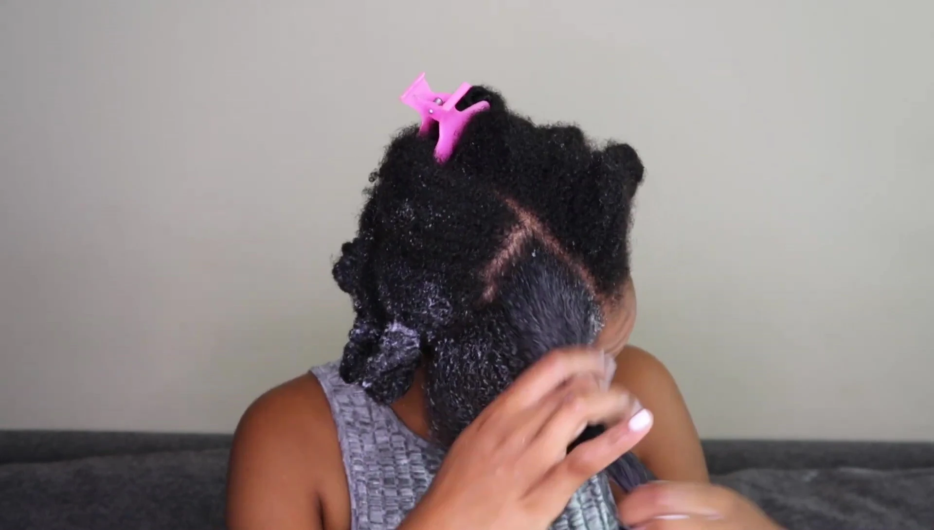 The YouTuber applying the hair mask to her damp hair