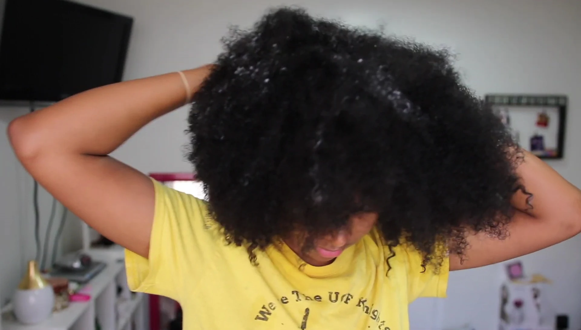 The vlogger demonstrating the sectioning of hair before steaming.