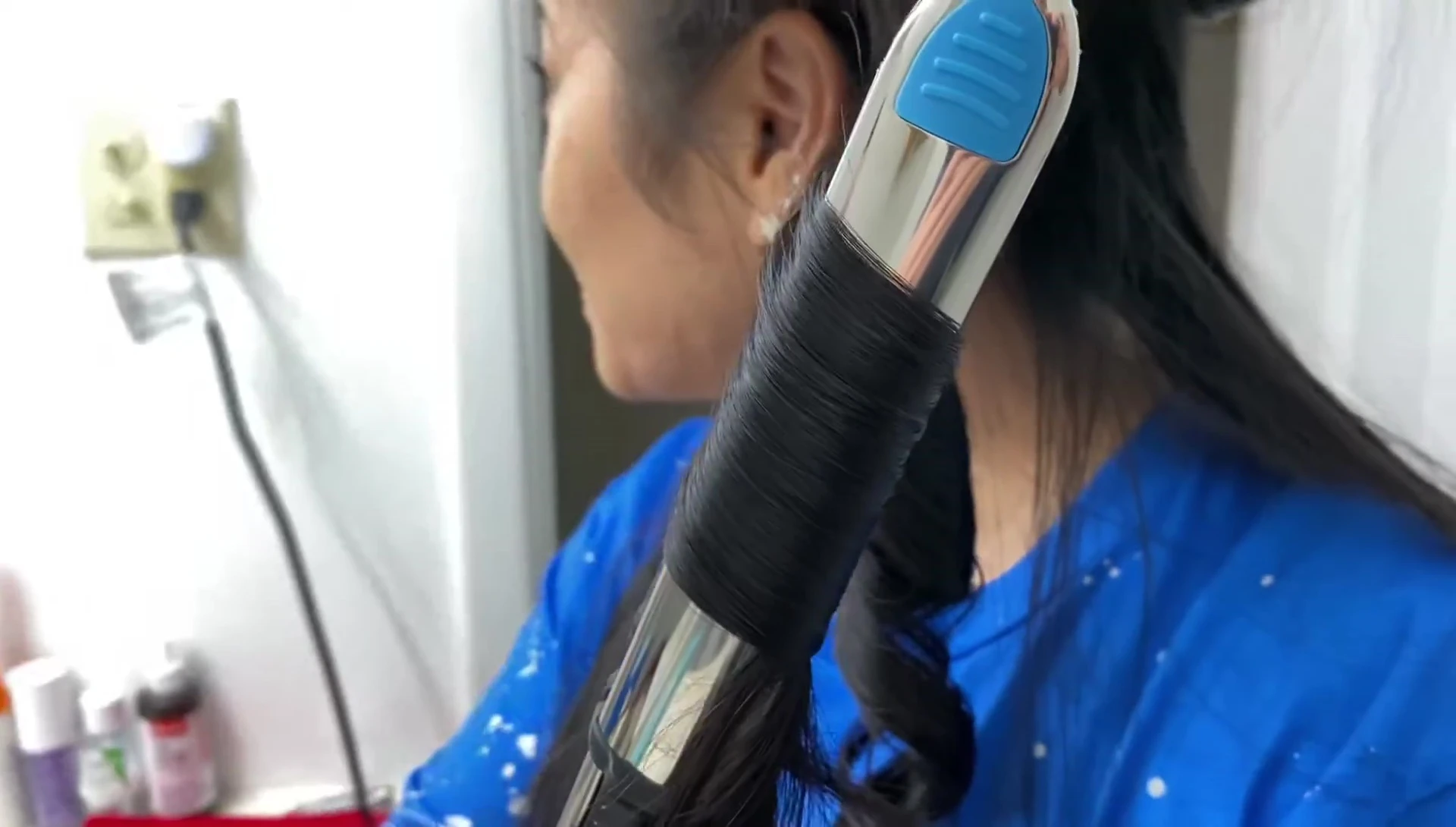 Creating curls with the Babyliss Pro Nano Titanium flat iron.