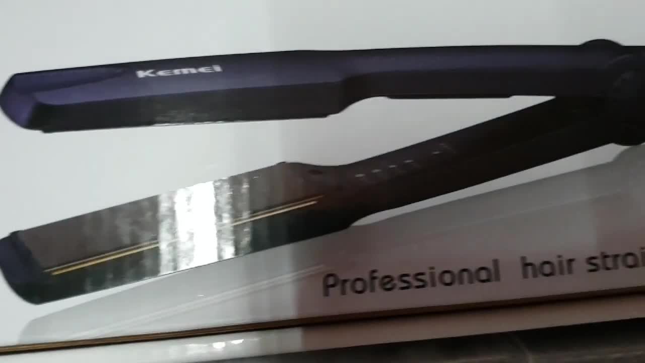 Close-up shot of the Kemei KM-329 hair straightener showing its compact size.