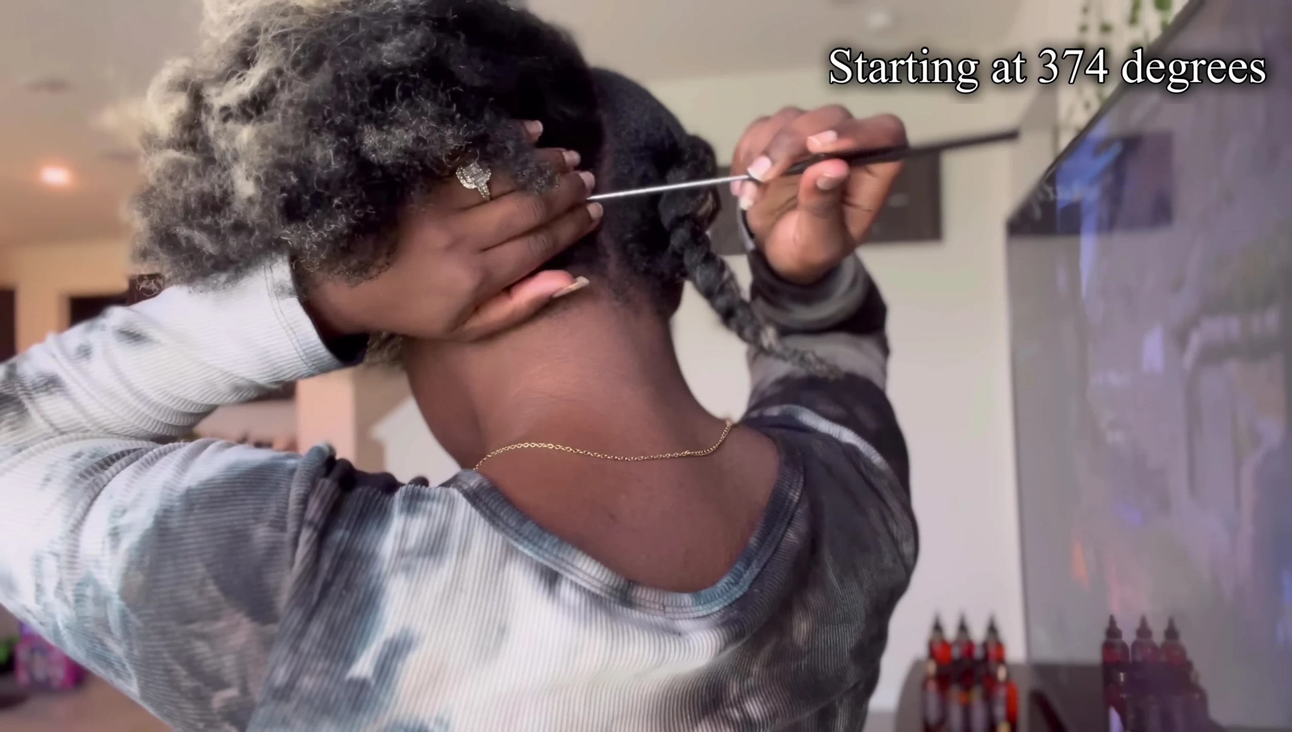 Sectioning hair and applying heat protectant.