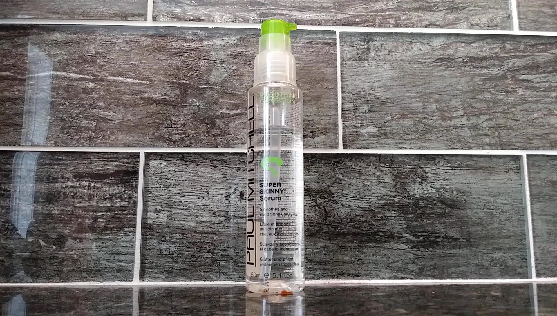 Applying serum to damp hair, focusing on the ends.
