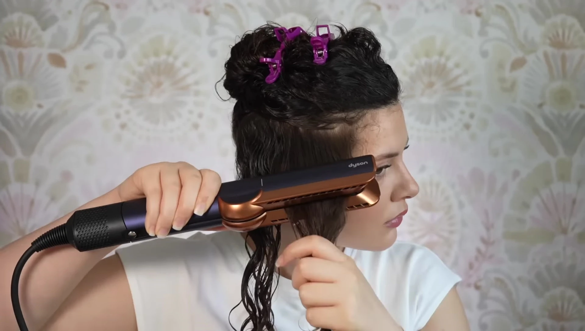 The reviewer demonstrating the tool on her own hair.
