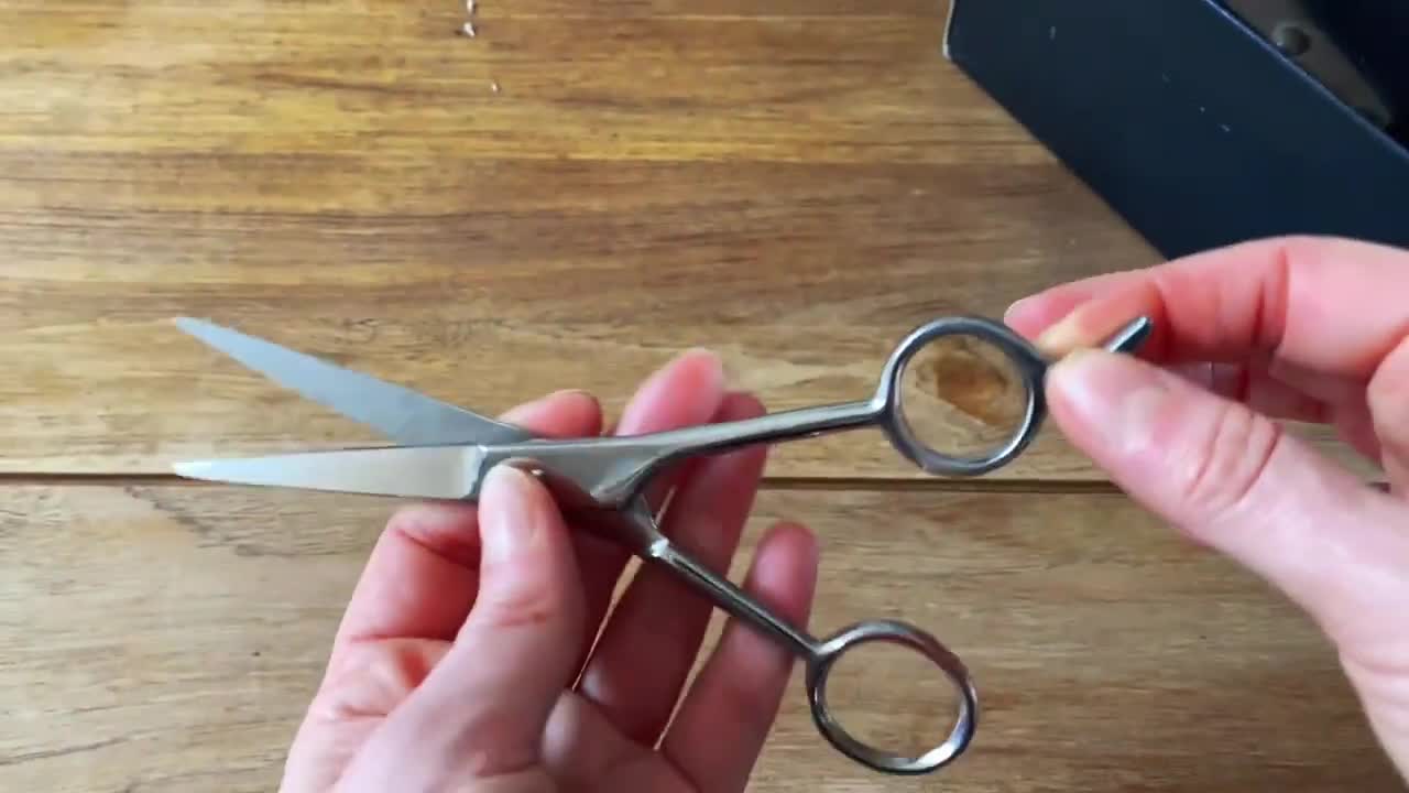 Close-up of the scissors being used for cutting