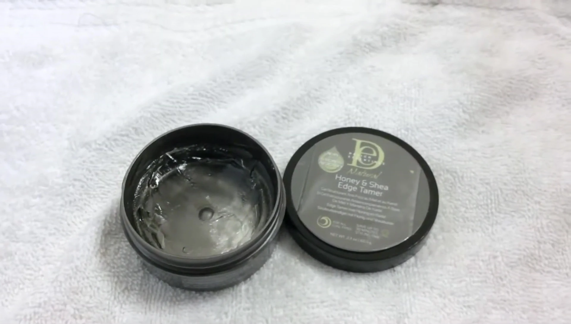 The reviewer applying the product to their hairline.