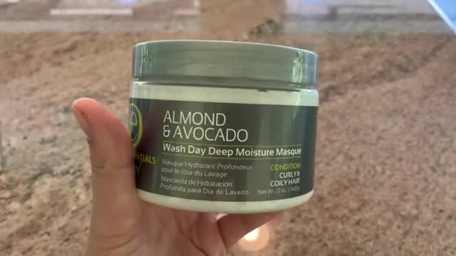 Close-up of the Design Essentials Almond & Avocado Curling Creme bottle.