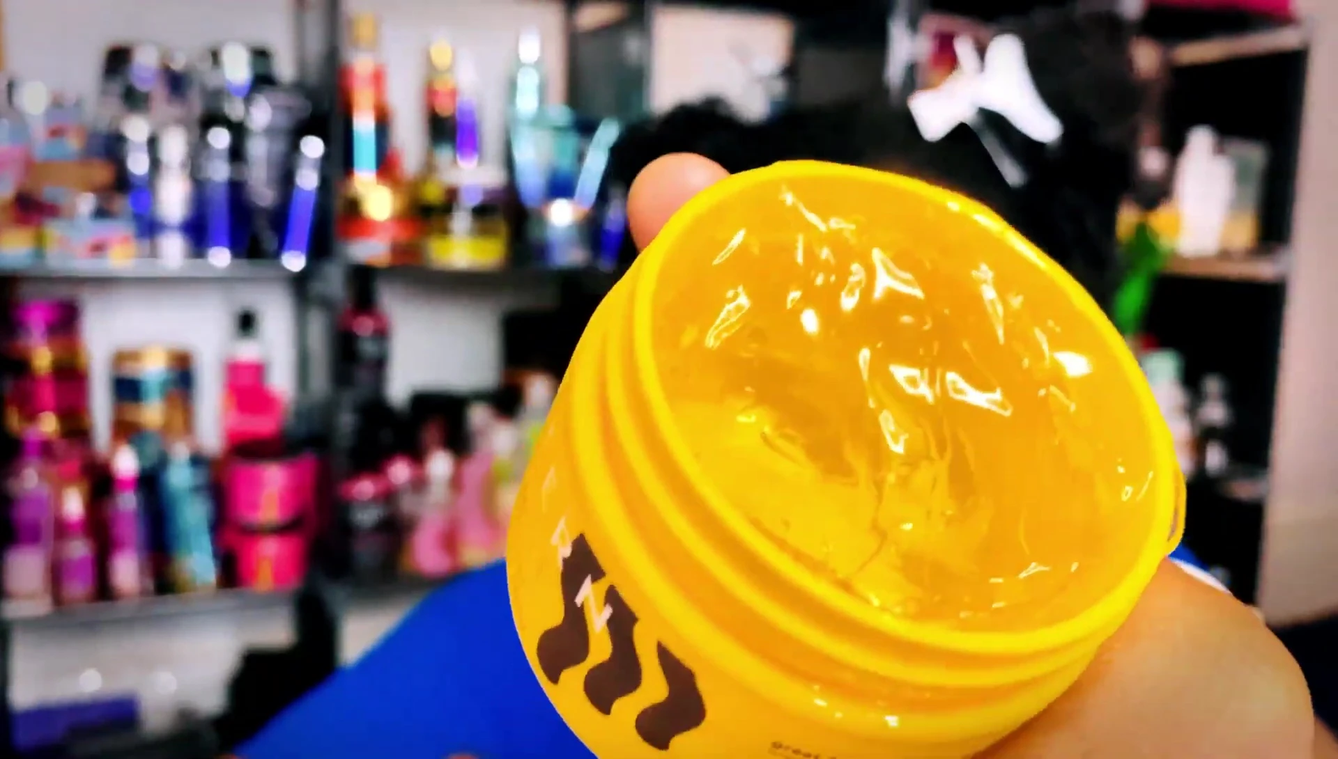 Close-up shot of the gel being applied to a curl.