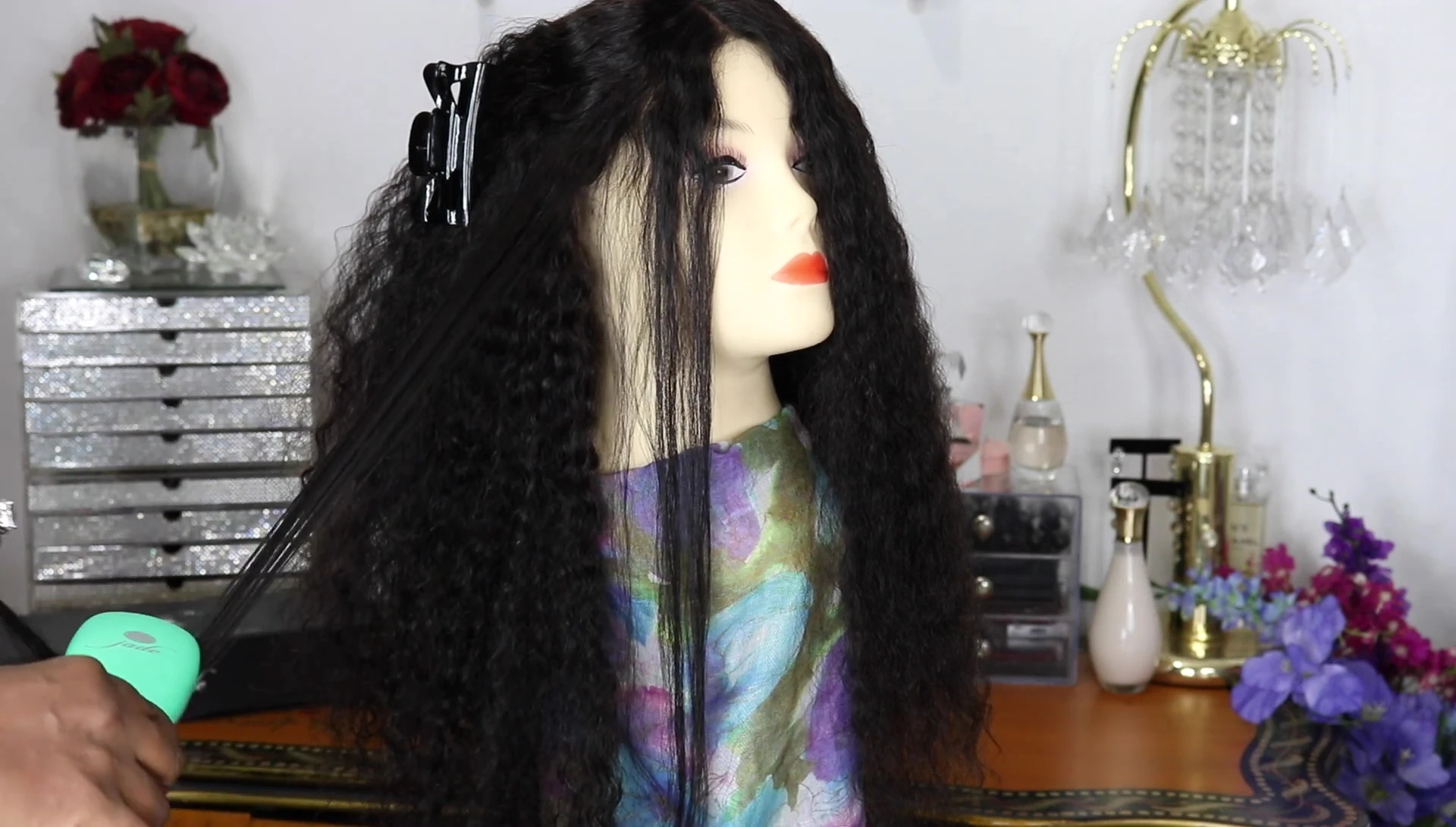 Demonstrating the technique of holding hair taut while brushing