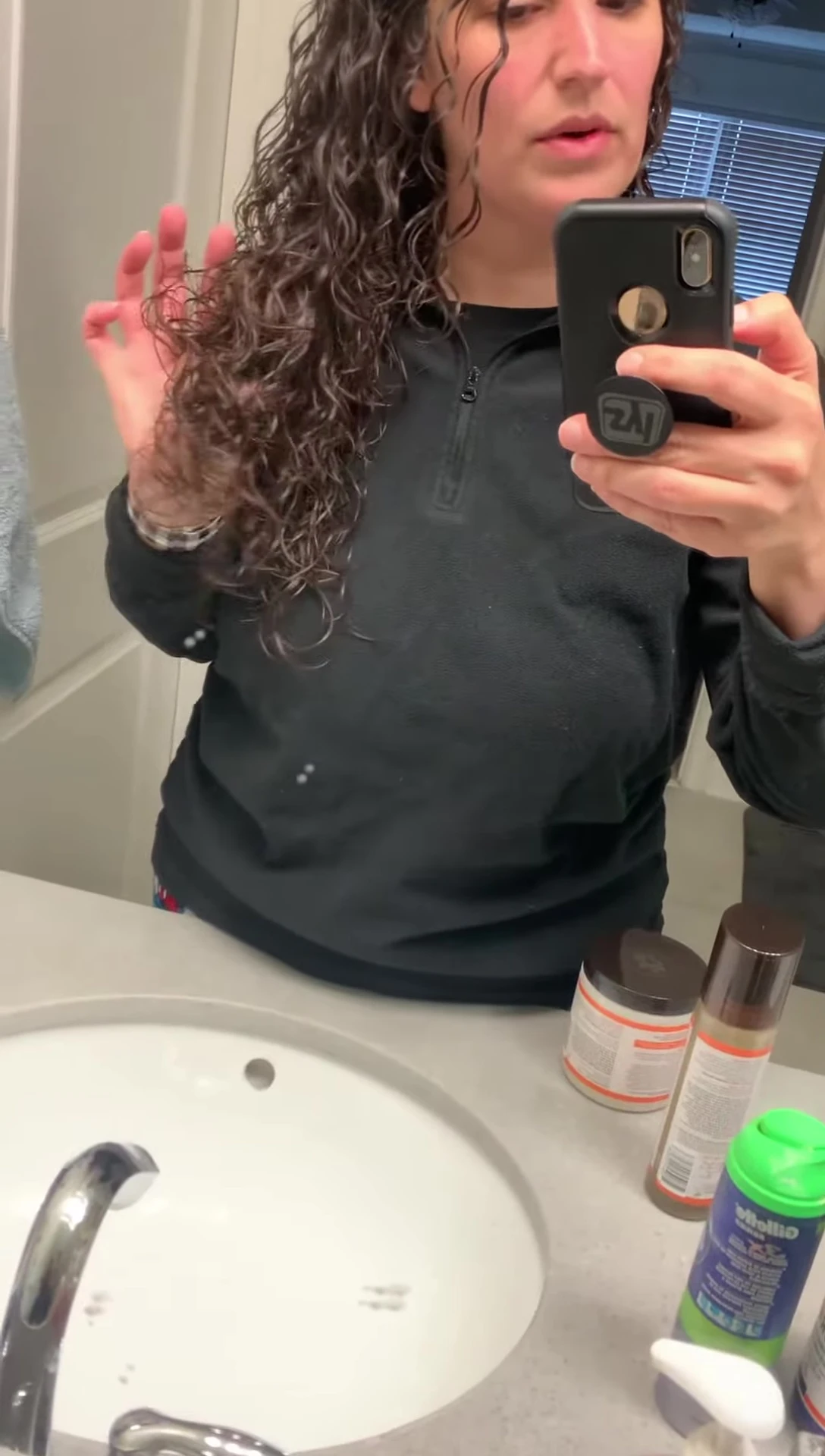 The individual spraying the product in their hair