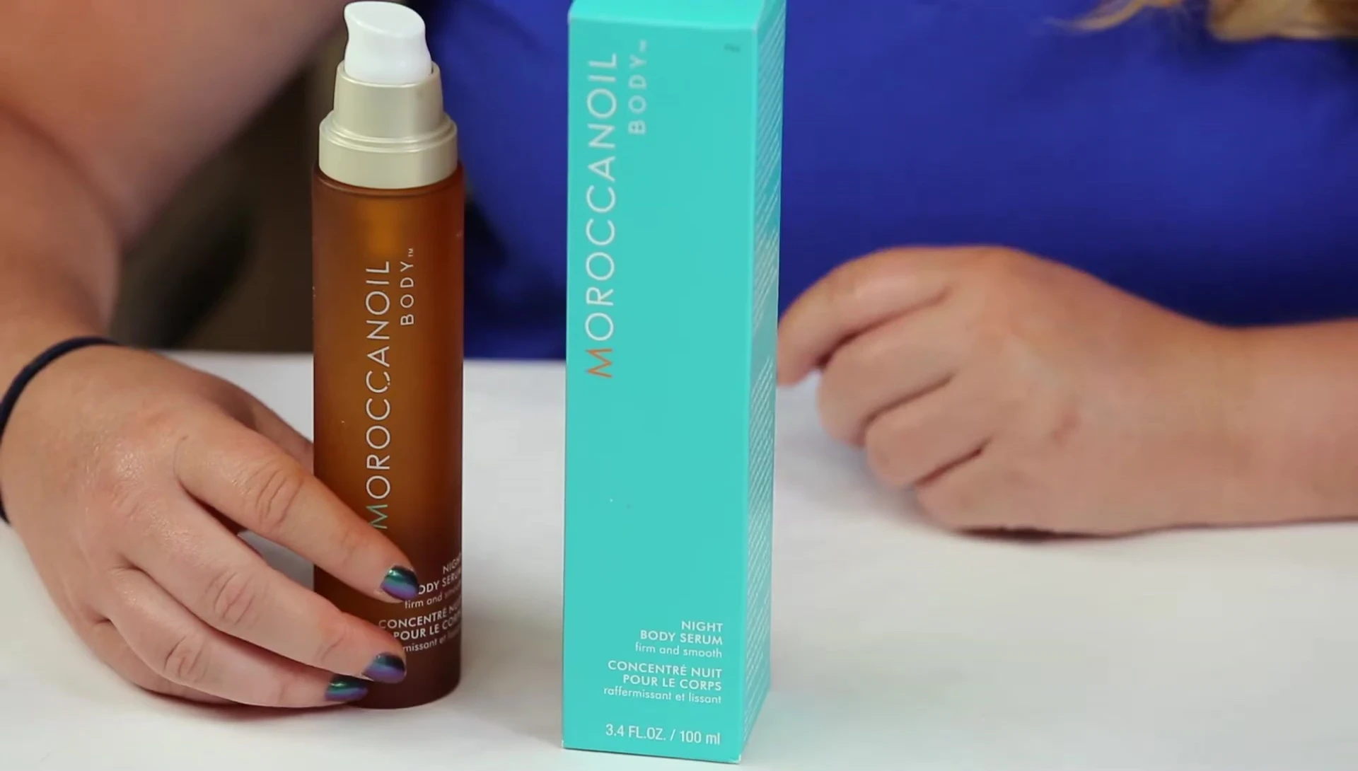 The reviewer applying the serum to their skin.